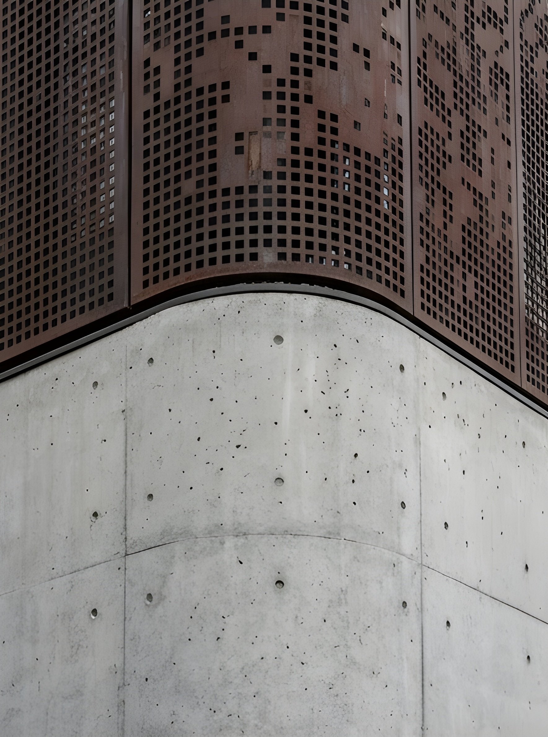 Curved perforated metal screen above board-formed concrete by Ranzospace