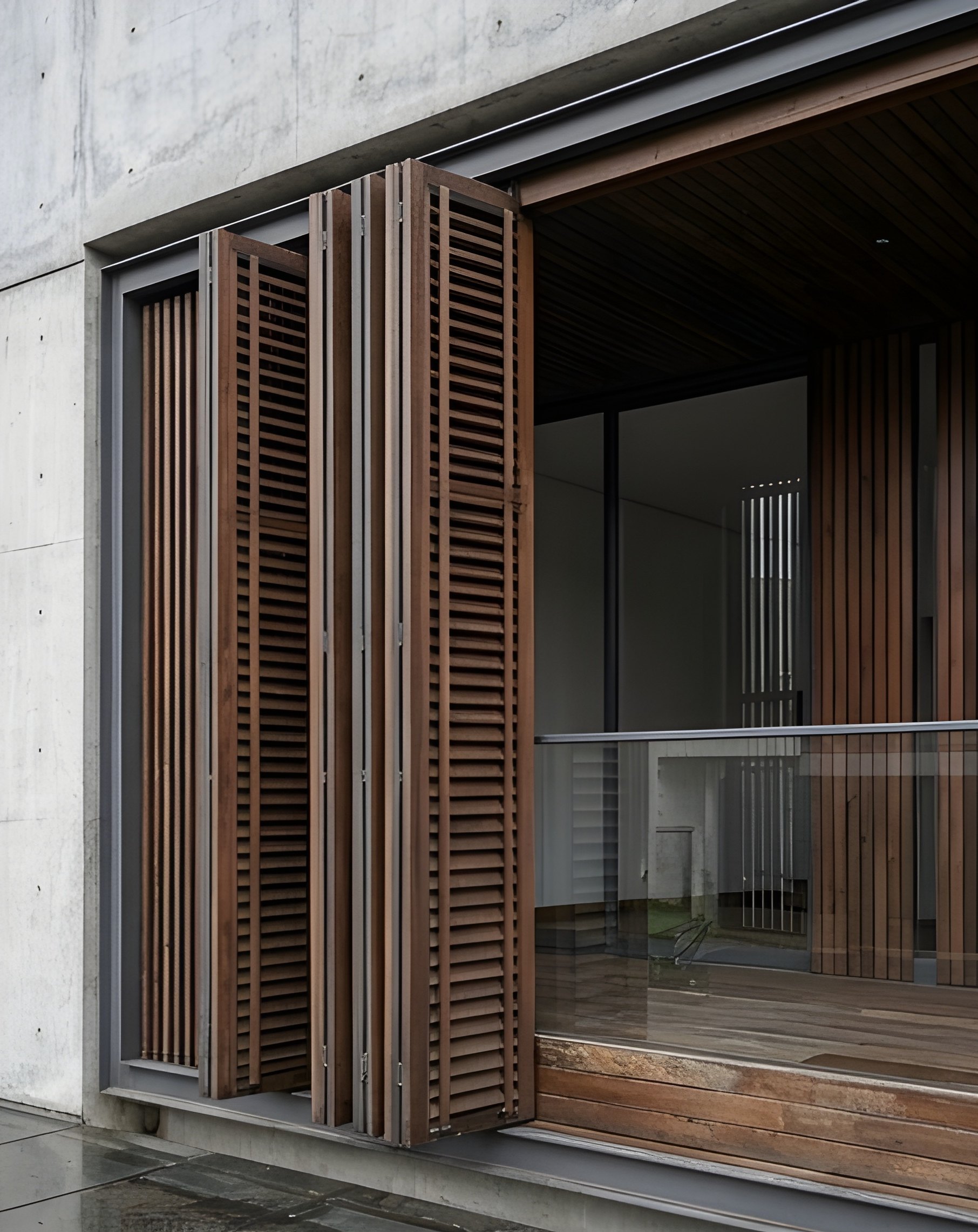 Folding timber shutters on a concrete residence by Ranzospace Mumbai